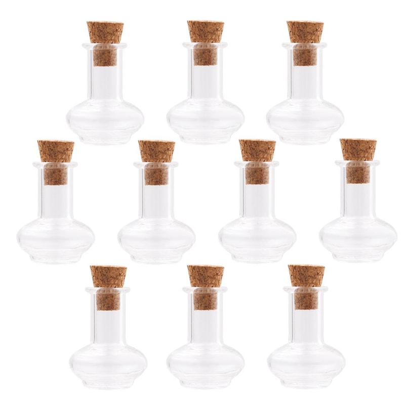 May include: Ten clear glass bottles with cork stoppers. The bottles are round and have a wide base. They are perfect for storing small items, such as essential oils, spices, or craft supplies.