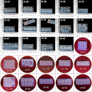 May include: A set of 16 clear silicone molds for crafting. The molds feature various designs, including hearts, stars, anchors, and animals. The molds are arranged in rows on a red surface.