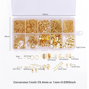 May include: A clear plastic storage box filled with various gold-colored metal jewelry findings. The box is divided into 10 compartments. The findings include jump rings, lobster clasps, earring hooks, beads, and more. The box measures 6.8 inches by 13 inches and is 2.1 inches high. Conversion: 1 inch = 25.4 mm or 1 mm = 0.0393 inch.