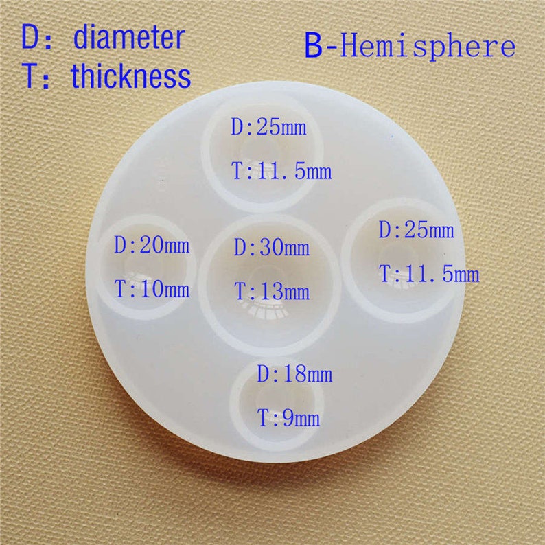 May include: A white silicone mold with five hemispherical cavities for resin casting. The mold has measurements for each cavity, including diameter and thickness in millimeters. The cavities are labeled with the measurements: 25mm, 11.5mm, 25mm, 11.5mm, 20mm, 10mm, 30mm, 13mm, and 18mm, 9mm.