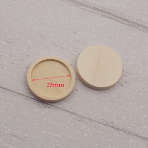 May include: Two round wooden bases for crafting projects. The base on the left has a 25mm diameter.