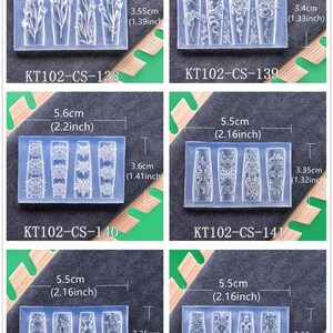 May include: Six clear silicone molds with various designs, including flowers, swirls, and ornate patterns. Each mold is approximately 2.16 to 2.36 inches long and 1.32 to 1.41 inches wide. The product codes KT102-CS-138 through KT102-CS-143 are visible.