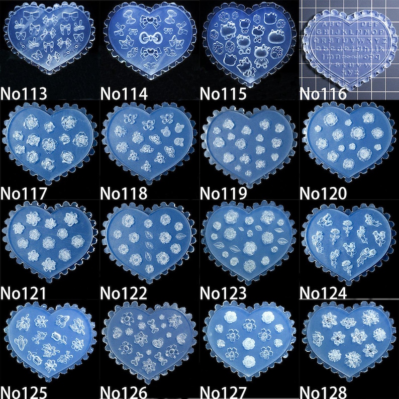 May include: A selection of blue heart-shaped nail art moulds. Each mould features a different design, including bows, flowers, and letters. The moulds are numbered from 113 to 128.