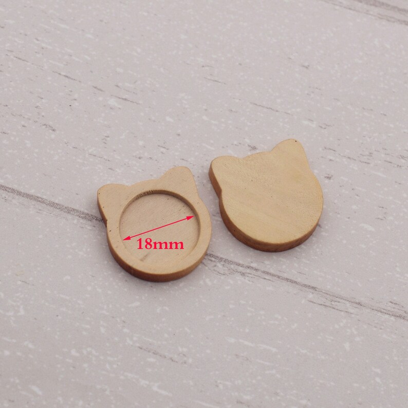 May include: Two wooden cat-shaped blanks with a 18mm round recess for resin or other embellishments.