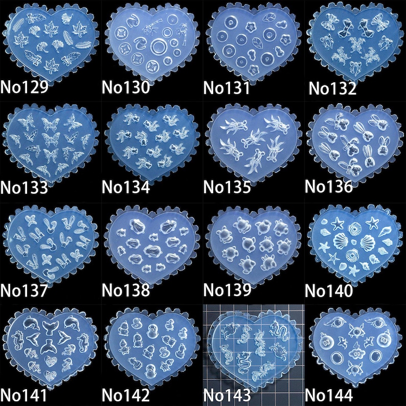 May include: A selection of heart-shaped moulds featuring diverse designs such as leaves, circles, butterflies, and marine life. Each mould is a translucent blue hue with a scalloped edge. Numbers from No129 to No144 are printed on the moulds.
