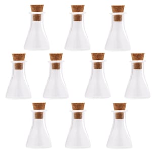 May include: Ten clear glass bottles with cork stoppers. The bottles are small and have a round bottom.