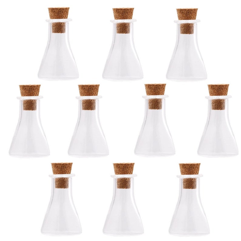 May include: Ten clear glass bottles with cork stoppers. The bottles are small and have a round bottom.