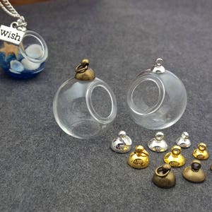 May include: A set of glass bottle charms with metal caps. The charms are round and have a hole in the side. The caps are available in gold, silver, and bronze. The charms are perfect for adding a unique touch to necklaces, bracelets, and other jewelry.