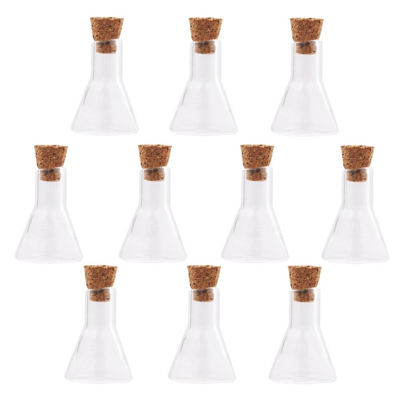 May include: Ten clear glass bottles with cork stoppers. The bottles are conical in shape and have a rounded bottom.