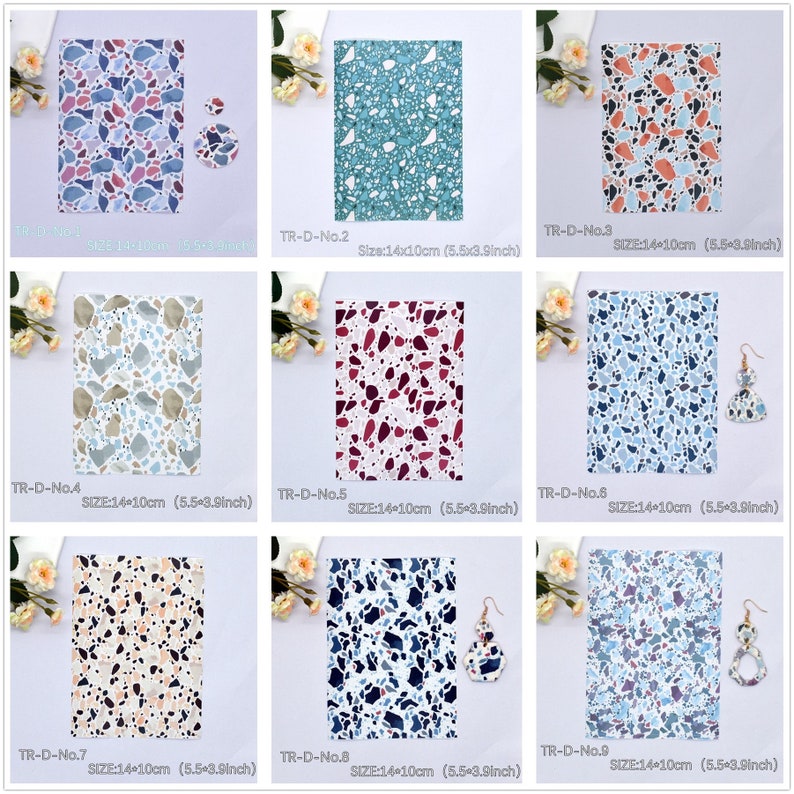 May include: Nine different patterned fabric swatches with a terrazzo design. Each swatch measures 14 by 10 cm. Some swatches have matching earrings with a terrazzo design.