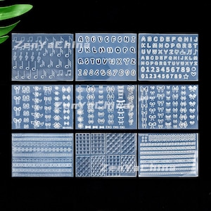 Puede incluir: Plantillas transparentes para nail art con varios diseños. Incluye notas musicales, letras, números, lazos y patrones de bordes decorativos. Perfectas para crear diseños de nail art detallados.