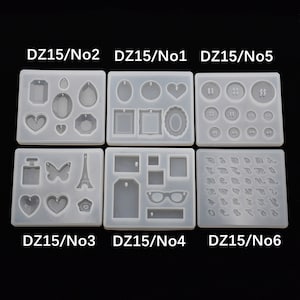 Peut inclure: Six moules en silicone transparents pour la création. Chaque moule présente différentes formes, notamment des cœurs, des boutons, des cadres, et plus encore. Les moules sont étiquetés avec le texte "DZ15/No1" à "DZ15/No6".