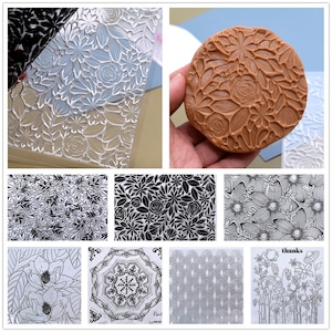 May include: A set of 10 clear and black silicone stamps featuring floral and geometric designs. The stamps are perfect for crafting and scrapbooking.