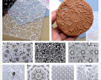 May include: A set of 10 clear and black silicone stamps featuring floral and geometric designs. The stamps are perfect for crafting and scrapbooking.