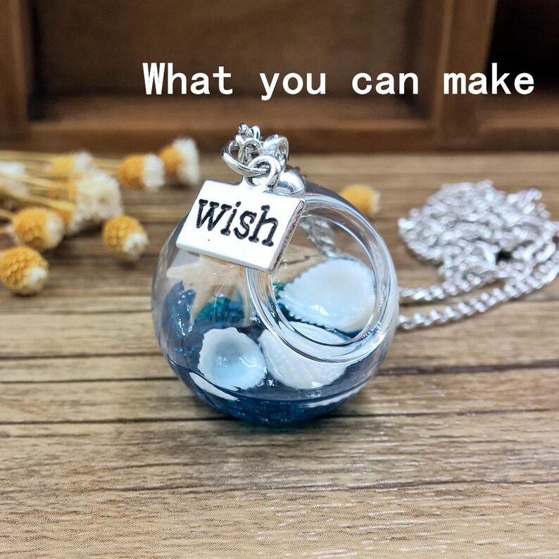 May include: A silver necklace with a glass orb pendant containing seashells and blue glitter. The orb has a silver charm attached that says "wish".