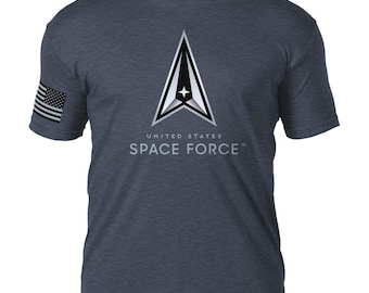 May include: A dark blue t-shirt with a white and silver Space Force logo. The logo features a star and the text "United States Space Force".