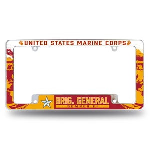 May include: A silver license plate frame with a red, yellow, and white design. The frame features the text "UNITED STATES MARINE CORPS" at the top and "BRIG. GENERAL SEMPER FI" at the bottom.