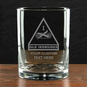 May include: A clear glass tumbler with etched design. The design includes a triangle with the number 1, a tank, and the words "OLD IRONSIDES". Below the design is the text "YOUR CUSTOM TEXT HERE".