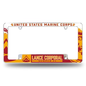 May include: A silver license plate frame with a red, yellow, and white design. The frame features the text "UNITED STATES MARINE CORPS" and "LANCE CORPORAL SEMPER FI".