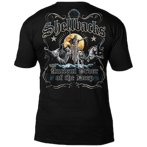 May include: Black t-shirt with a graphic print of a nautical scene. The graphic features a man riding a seahorse with other sea creatures surrounding him. The text "Shellbacks The Ancient Order of the Deep" is printed on the shirt.