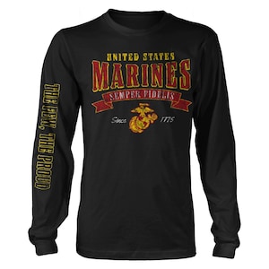 May include: Black long-sleeve t-shirt with a vintage-style graphic of the United States Marines logo. The text reads "United States Marines, Semper Fidelis, Since 1775". The left sleeve has the text "The Few, The Proud" in yellow.