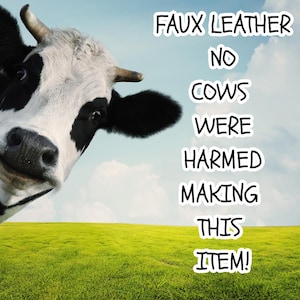 May include: A black and white cow head is positioned on the left side of the image against a green field and blue sky. The text FAUX LEATHER NO COWS WERE HARMED MAKING THIS ITEM! is written in white capital letters with a black outline on the right.