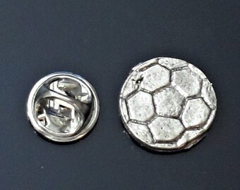 Young boy footballer pin badge Kicking a ball novelty lapel pin.
