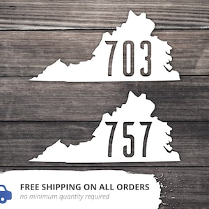May include: Two white vinyl decals shaped like the state of Virginia with the numbers "703" and "757" printed in black.