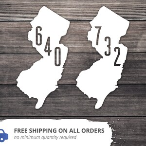 May include: Two white outlines of the state of New Jersey with the area codes 640 and 732 printed inside.