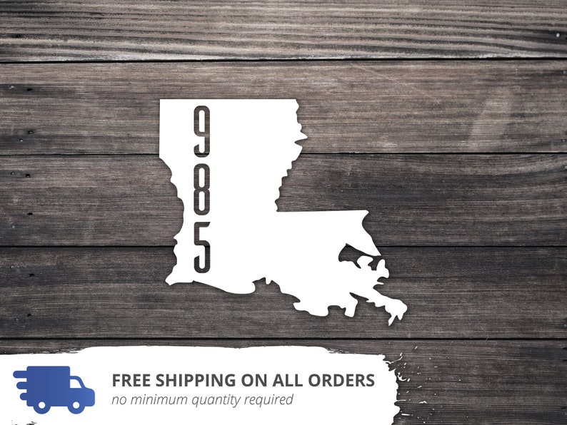 May include: White silhouette of the state of Louisiana with the numbers 905 printed vertically on the left side. The image is on a woodgrain background.