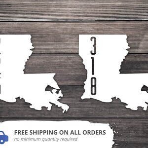May include: Two white outlines of the state of Louisiana with black numbers inside. The left outline has the numbers 225 and the right outline has the numbers 318.