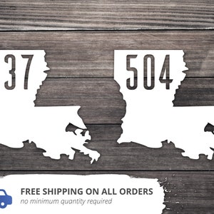 May include: Two white outlines of the state of Louisiana with the area codes 337 and 504 printed inside.