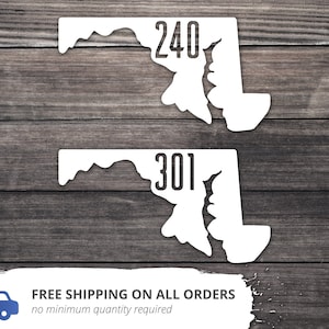 May include: Two white vinyl decals shaped like the state of Maryland. The top decal has the number 240 printed on it. The bottom decal has the number 301 printed on it.