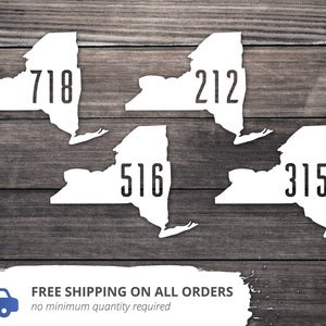 May include: Four white outline maps of New York State with the area codes 718, 212, 516, and 315 printed inside each map.
