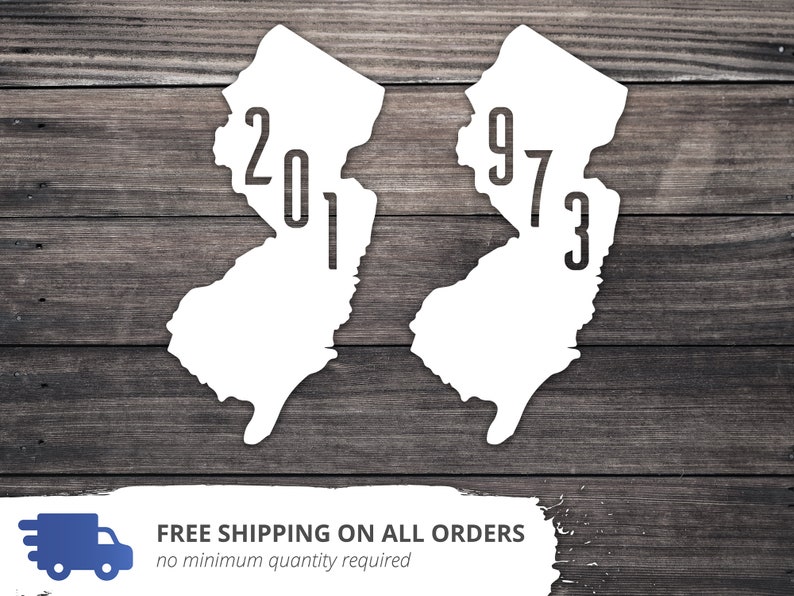 May include: Two white outlines of the state of New Jersey with the years 1973 and 2017 printed inside. The outlines are on a woodgrain background.