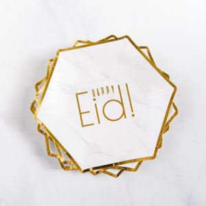 May include: Gold foil paper plates with a marble pattern and the text "Happy Eid!" printed in gold.