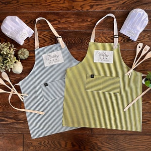 Hubby and wifey classic striped aprons in green and white as well as blue and white from 100% cotton as second wedding anniversary gift. You can add the date as well as matching chef hats and wooden cooking tools.