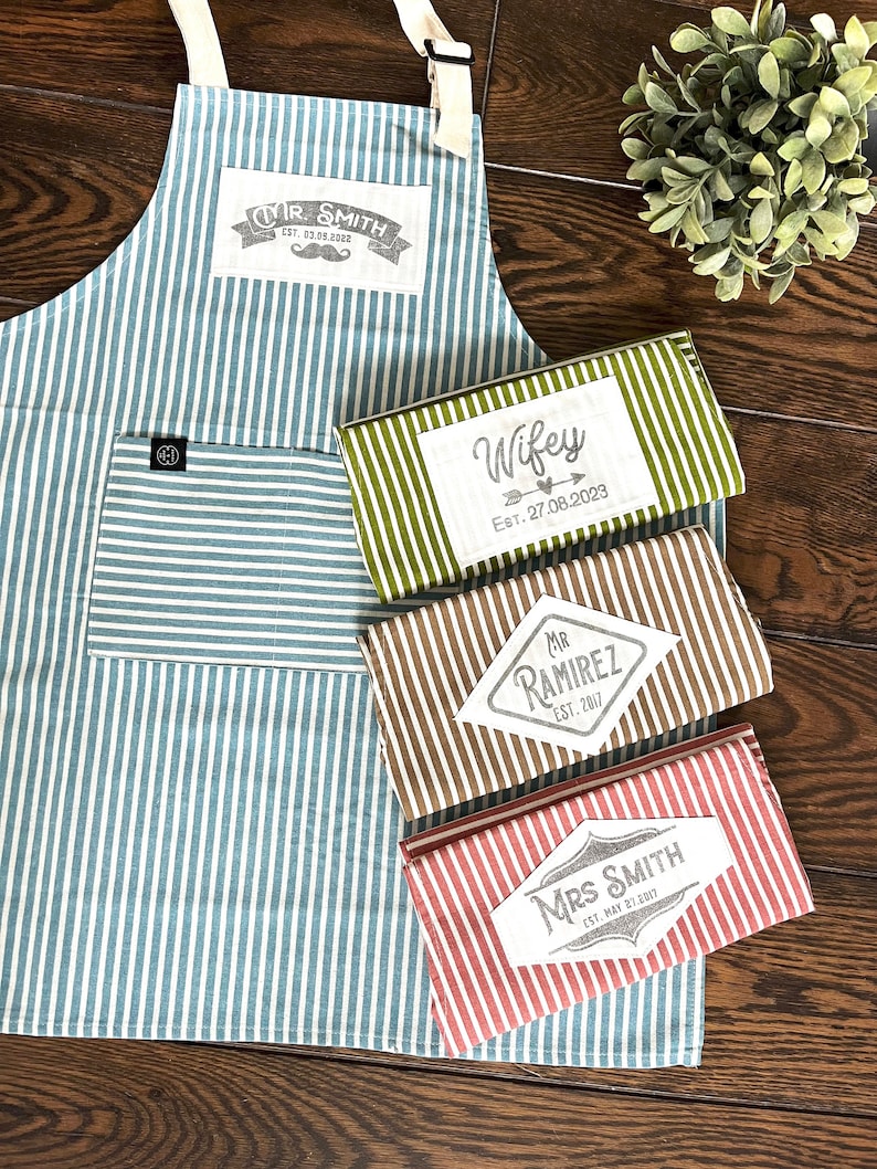 Classic striped quality cotton aprons in green, blue, beige, red and white stripes. Customized with hand printed graphic patches and the text, date and names you want. The unique custom gift for anniversaries, weddings, birthdays.