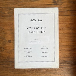 May include: A black and white program for the musical "Venus on the Half Shell" presented by Billy Rose. The musical was staged by John Murray Anderson, with music by Dana Suesse, lyrics by Billy Rose, and musical direction by Noble Sissle.