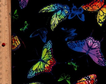 May include: Black fabric with a vibrant pattern of colorful butterflies. The butterflies feature a variety of colors, including blue, purple, yellow, and red. The wings have detailed patterns, and the background is solid black.