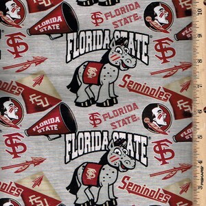 May include: A grey fabric with a repeating pattern of Florida State Seminoles logos, including a cartoon Seminole mascot, a megaphone, and the words "Florida State".