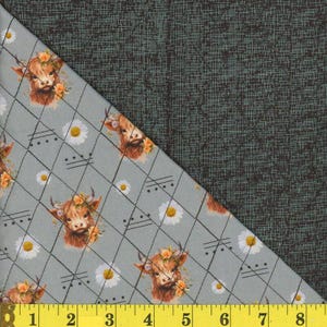 May include: Fabric with a light gray background featuring a repeating pattern of Highland cows adorned with floral crowns and daisies. The design is set within a diamond grid. The other half of the fabric has a dark green textured pattern.