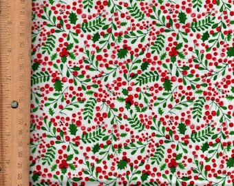 May include: White fabric with a repeating pattern of red berries, green leaves, and holly. The fabric is decorated with a ruler along the left side. The fabric is made in the USA.
