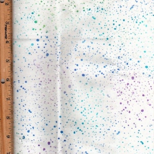 May include: White fabric with a scattered pattern of small blue, green, and purple dots.