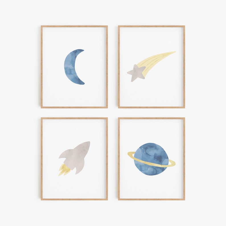 May include: Set of four watercolor prints featuring space-themed illustrations. The prints depict a crescent moon, a shooting star, a rocket ship, and a planet with rings. The illustrations are in shades of blue, gray, and yellow.