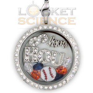 May include: Silver locket necklace with a clear glass insert. The locket has a silver chain and is decorated with rhinestones. The glass insert contains a baseball, rhinestones, and the words "I love you" and "HOU".