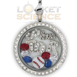 May include: Silver locket necklace with a clear glass insert. The locket features a baseball, red and blue gems, and the words "I love you" and "TOR" in rhinestones.