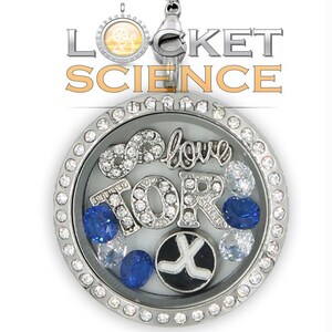 May include: Silver locket necklace with a clear glass insert. The locket contains charms that spell "I love TOR" with a hockey stick charm. The locket is surrounded by a silver border with clear rhinestones.