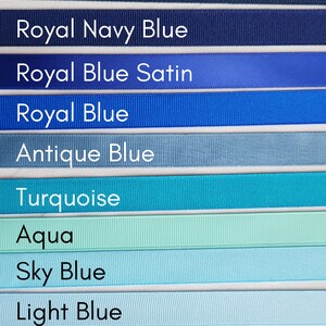May include: A collection of ten different shades of blue ribbon, from navy blue to pale blue. The ribbon is arranged in a vertical stack, with the darkest shade at the top and the lightest shade at the bottom. The ribbon is labelled with the colour name in white text.