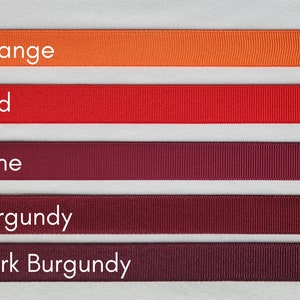 May include: Five different colours of ribbon, from left to right: orange, red, wine, burgundy, and dark burgundy.